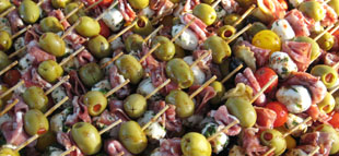 Goat cheese stuffed figs, wrapped in prosciutto... roasted with a honey balsamic drizzle